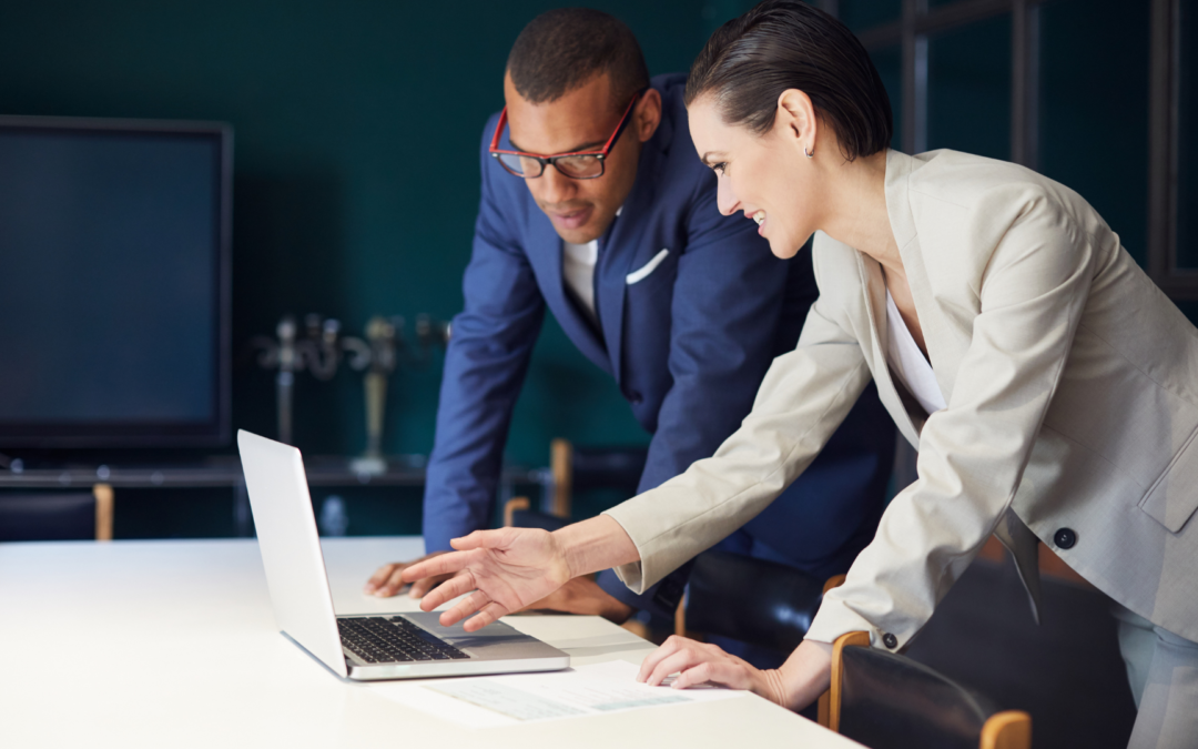 An aspiring entrepreneur in consultation with a Meritus Group broker, exploring business buying opportunities