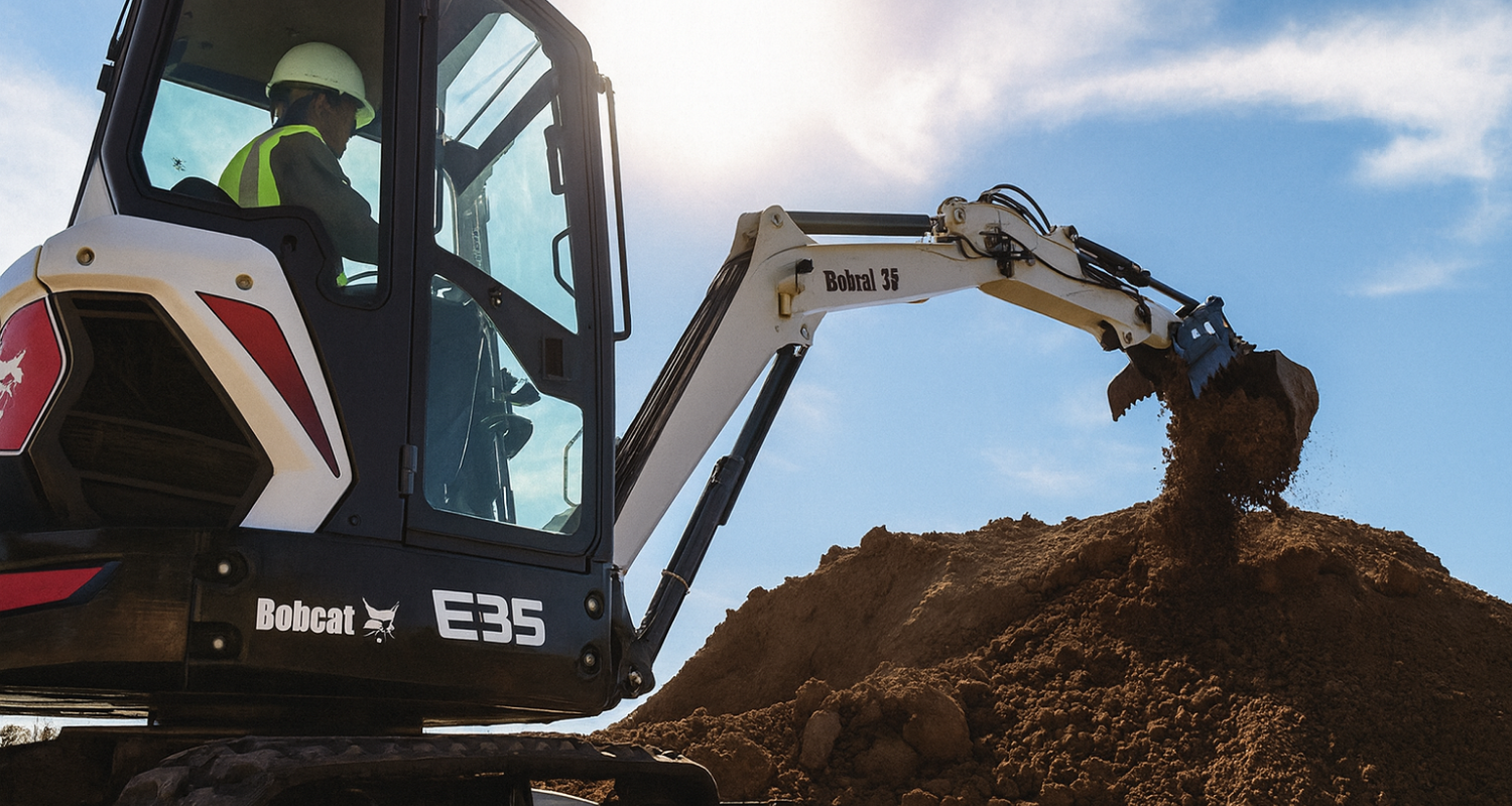 Operator using a Bobcat E35 excavator to move soil at a job site in South Dakota.